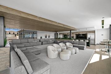 Salt Lake City apartment for rent - A modern living room with a large grey sofa and a wooden ceiling.
