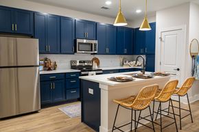 Charleston apartment for rent - A kitchen with blue cabinets and a white island.