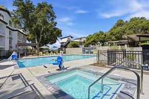 Vallejo apartment for rent - A swimming pool with a blue chair and a metal railing.