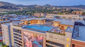 Salt Lake City apartment for rent - A large building with a pool and a mural on the side.