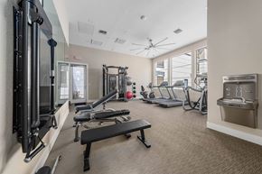 Phoenix apartment for rent - A gym with a variety of equipment including a treadmill, weights, and a bench.