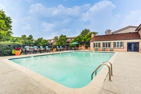 Aurora apartment for rent - A large outdoor swimming pool with a metal ladder on the side.