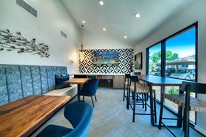 Scottsdale apartment for rent - a dining area with tables and chairs and a large window