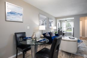 Orlando apartment for rent - A modern dining room with a glass table and chairs.