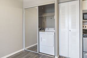 Orlando apartment for rent - A white kitchen with a dishwasher and a microwave.