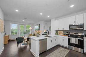 Asheville apartment for rent - A modern kitchen with white cabinets and stainless steel appliances.