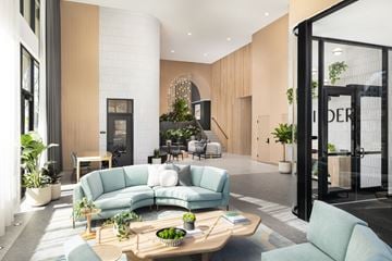 Denver apartment for rent - A modern living room with a large sectional sofa and a coffee table.
