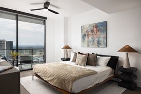 Denver apartment for rent - A bedroom with a large bed and a painting on the wall.