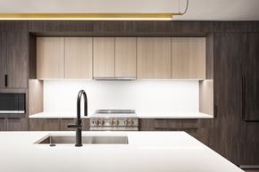 Denver apartment for rent - A modern kitchen with a stainless steel sink and a stove top.
