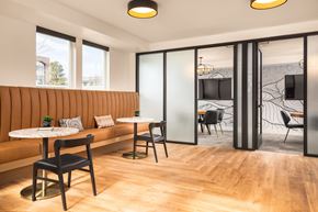 Lakewood apartment for rent - a lounge area with tables and chairs and a television with private work room
