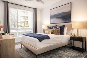 Lakewood apartment for rent - a bedroom with a bed and a large window