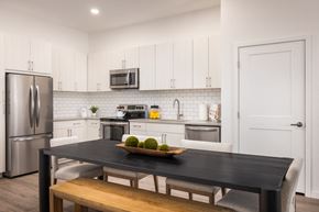 Lakewood apartment for rent - a kitchen with stainless steel appliances and a table