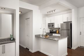 Glendale apartment for rent - A kitchen with white cabinets and a granite countertop.