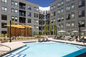 Denver apartment for rent - a swimming pool in front of a large apartment building
