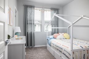 Broomfield townhouse for rent - a bedroom with a white bunk bed and gray walls and a window