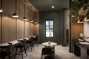 Parker apartment for rent - A modern dining area with a long table and chairs.
