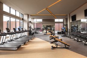 Denver apartment for rent - Fitness center with treadmills and other exercise equipment and windows