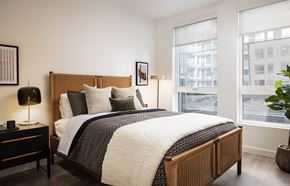 Denver apartment for rent - a bedroom with a bed and two windows