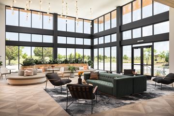 Denver apartment for rent - A modern living room with a green sofa and a fireplace.