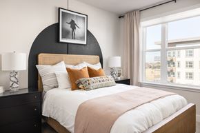 Aurora apartment for rent - a bedroom with a large bed and a large window