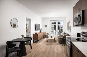 Denver apartment for rent - A modern kitchen with a dining table and chairs.