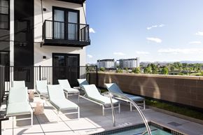 Denver apartment for rent - A balcony with chairs and a pool.