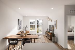 Aurora apartment for rent - A modern dining room with a wooden table and chairs.
