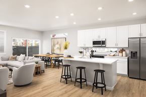 Aurora apartment for rent - A modern kitchen with white cabinets and a large island.