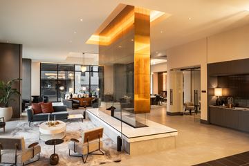 Denver apartment for rent - A modern living room with a large sectional sofa and a coffee table.