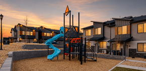 Bluffdale townhouse for rent - A playground with a blue slide and a red and black structure.