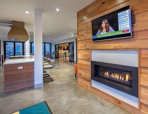 Bothell apartment for rent - A modern living room with a fireplace and a flat screen TV mounted on the wall.