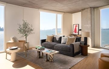 San Francisco apartment for rent - a living room with a gray couch and a view of the ocean
