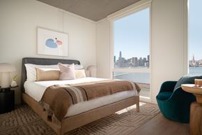 San Francisco apartment for rent - a bedroom with a view of the water and a bed and a chair