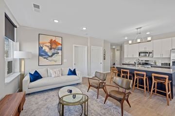 Covington apartment for rent - A living room with a white couch and a painting on the wall.