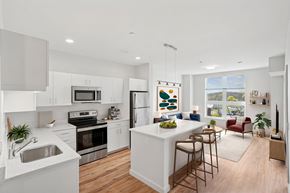 Beverly apartment for rent - A modern kitchen with white cabinets and a large island.