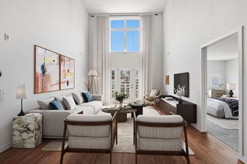 Fairfield apartment for rent - A living room with a large window, a sofa, a coffee table, and a painting on the wall.