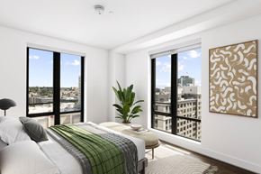 Stamford apartment for rent - a bedroom with a large bed and two large windows