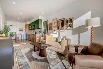 Salt Lake City apartment for rent - A living room with a brown couch and a rug.