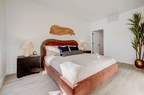 Salt Lake City apartment for rent - A bedroom with a large bed and a wooden headboard.