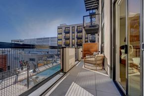 Salt Lake City apartment for rent - A balcony with a pool and a chair.
