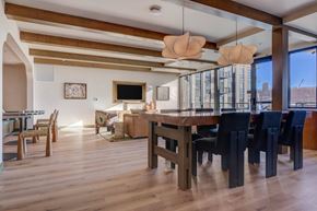 Salt Lake City apartment for rent - A modern dining room with a wooden table and chairs.