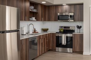 Vancouver apartment for rent - A modern kitchen with wooden cabinets and stainless steel appliances.
