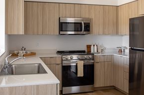 Vancouver apartment for rent - Modern kitchen with wooden cabinets and stainless steel appliances at The Arvon, Vancouver, 98662
