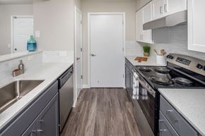 Tualatin apartment for rent - a kitchen with gray cabinets and white countertops