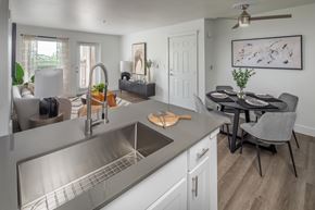 Tigard apartment for rent - A modern kitchen with a dining table and chairs.
