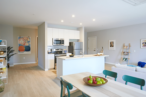 Hyattsville apartment for rent - a kitchen and living room with a table and a bowl of fruit