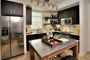 Santa Rosa apartment for rent - Kitchen with a stainless steel refrigerator and a wooden island at Annadel Downtown Santa Rosa apartments.