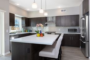 Oakland apartment for rent - a kitchen with a large white island with two chairs in front of it