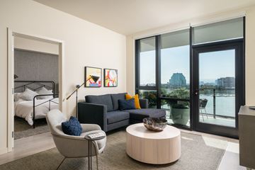 Los Angeles apartment for rent - a living room with a couch and a coffee table and a bedroom with a balcony
