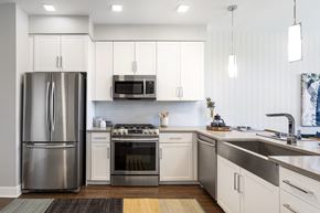 Parker apartment for rent - a kitchen with white cabinets and stainless steel appliances
